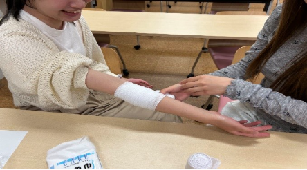 学生同士で腕への包帯法を確認しながら実践